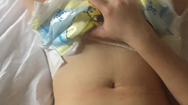 Little girl plays with her diaper