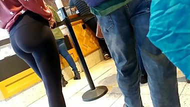 Candid teen in leggings ice cream shopping